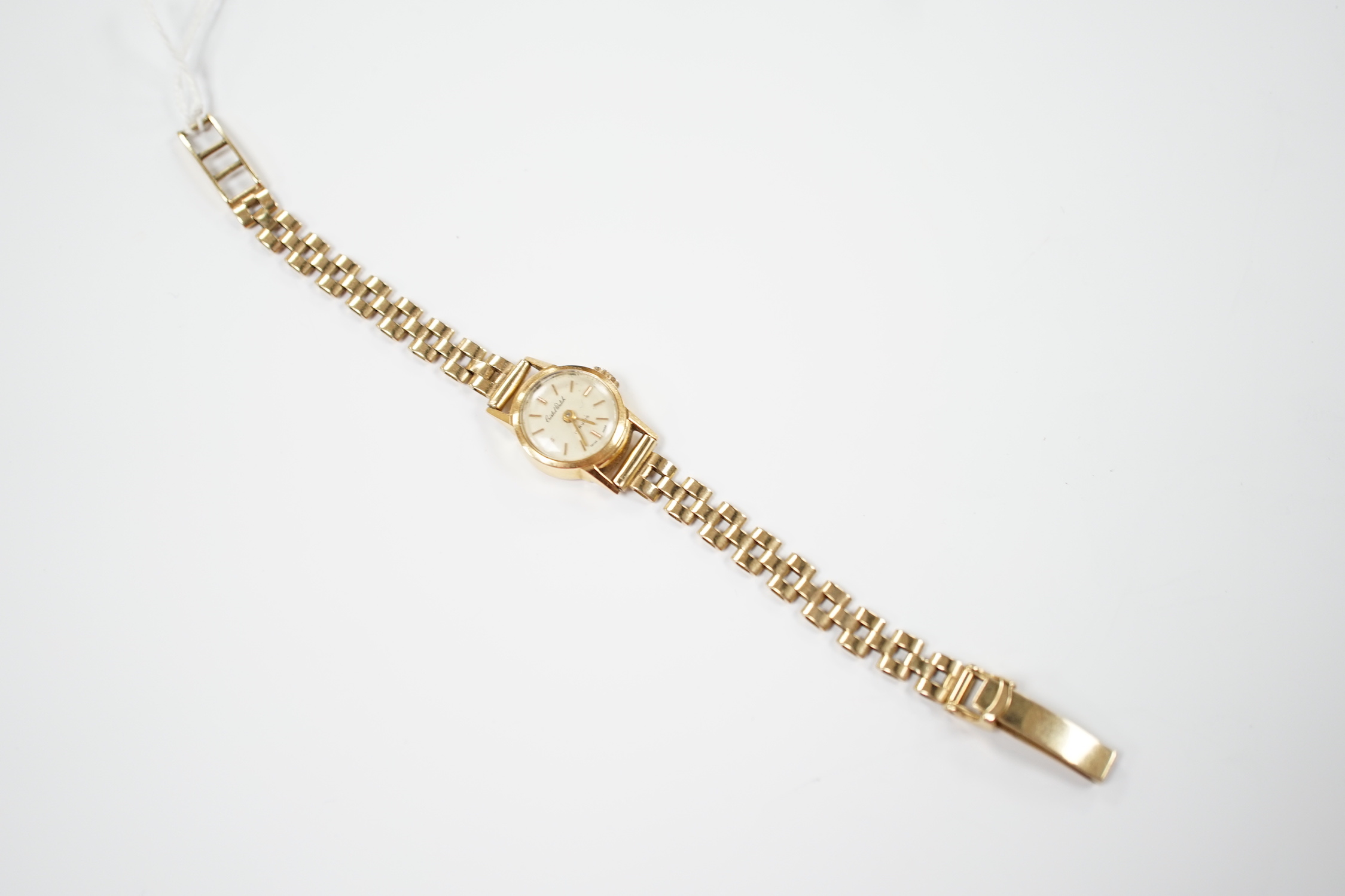 A lady's 18ct gold manual wind Cristal Watch, on a 1960's 9ct gold bracelet, overall length 16cm